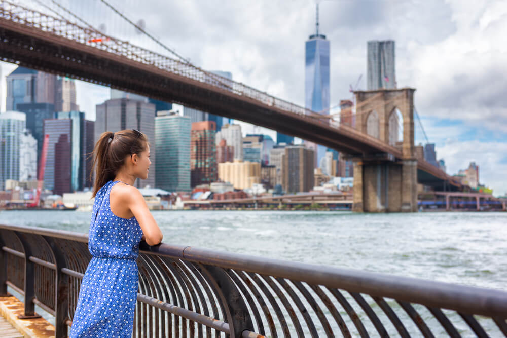 New York summer travel tourist woman enjoying Manhattan view from Brooklyn park, living happy lifestyle walking during vacation in United States