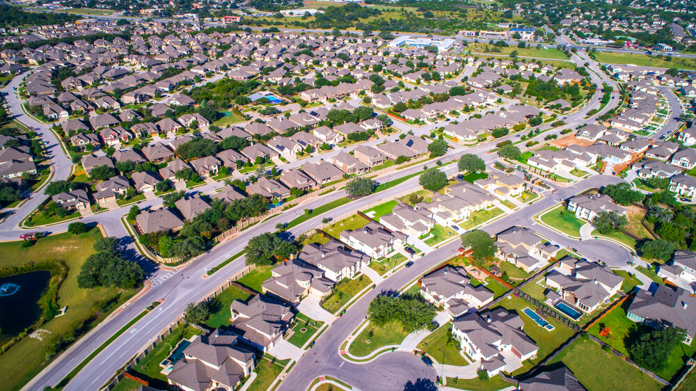 thousands of Homes and Rooftops Round Rock , Texas , USA aerial drone view high above Suburb Neighborhood with Vast amount of Homes near Austin , TX