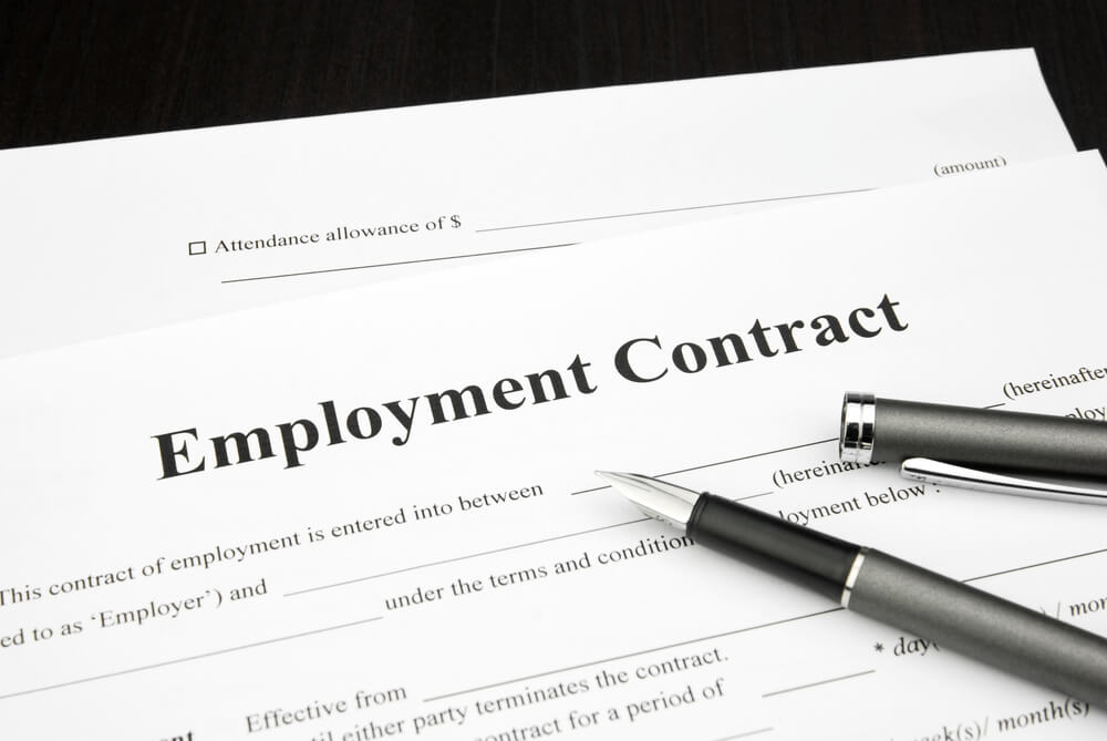 employment contract document form with pen